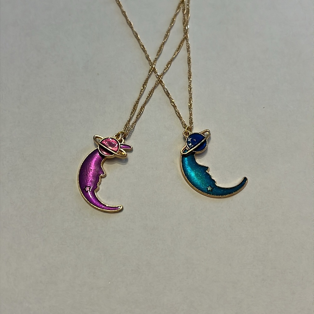 Moon pendant in gold with small planet charm. Purple or blue option.